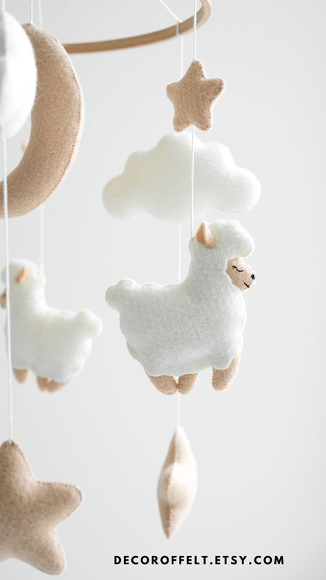 This sheep baby mobile is made in natural and neutral colors. It is perfect in the nursery of your baby, regardless of gender. This is a great gift for a baby shower. Nursery Design Board, Baby Play Gym Toys, Play Gym Toys, Lamb Nursery, Baby Lamb Baby Shower, Moon Mobile, Handmade Baby Gift, Baby Play Gym, Nursery Decor Ideas