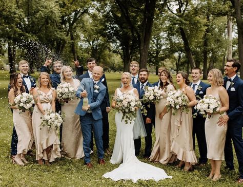 Gold Bridesmaid Dresses With Blue Suits, Tan Bridesmaid Dresses Navy Suits, Navy Sage And Tan Wedding, Winter Wedding Champagne Bridesmaids, Suits To Go With Champagne Dress, Champagne Bridesmaid Dresses Blue Flowers, Navy Suit Bridal Party, Taupe And Beige Wedding, Taupe Bridesmaid Dresses Navy Suits