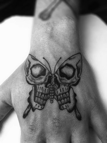 Skull Butterfly Tattoos on Wrist Tattoo Catholic, Skull Butterfly Tattoo, Small Skull Tattoo, Herren Hand Tattoos, Borboleta Tattoo, Butterfly Tattoo On Shoulder, Skull Hand Tattoo, Butterfly Tattoo Meaning, Tattoo Placements