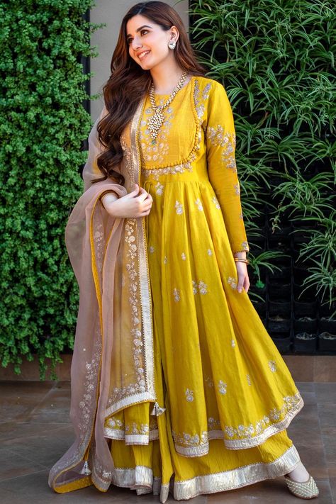 Featuring a glaze mustard anarkali in silk chanderi base with kashmiri tilla, pearls, and gota embroidery. It is paired with a matching crushed cotton skirt and a daisy ivory silk organza dupatta.The biggest luxury blowout end of season sale up to 50% off Anarkalis to Adore.#Perniaspopupshop #womenswear #ethnic #whatiworewastrending #ppuslove #anarkaliset #organza #chanderisilk #cotton #gotaembroidery #pearlsembroidery #weddingwear #festivewear #sangeet #haldi #weddingceremony