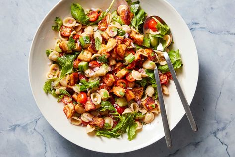 Crispy, salty, chewy cubes of sautéed halloumi add great texture and heartiness to this bright pasta salad filled with veggies, herbs and tomatoes The tomatoes are marinated with red wine vinegar, oil, salt and pepper, which infuses them with flavor and helps them release their juices for the punchy dressing Crunchy cucumbers, lots of fresh herbs and some optional arugula round out this hearty salad Crouton Recipes, Three Bean Salad, Roasted Shrimp, Roasted Chicken Thighs, Squash Salad, Hearty Salads, Small Pasta, Nyt Cooking, Croutons