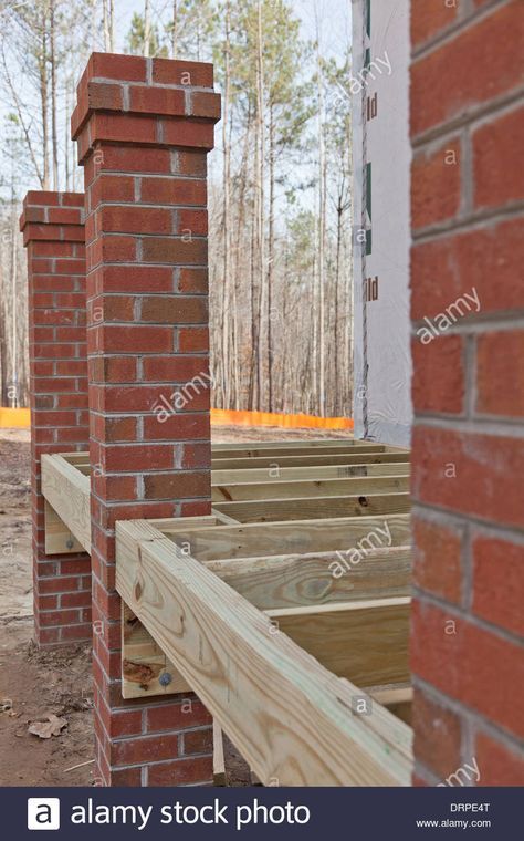 New home construction wood framing details of a porch with brick columns Stock Photo Brick Post Columns, Brick Columns Porch, Brick Pillars Porch, Stairs Backyard, Brick Pillars, Brick Porch, Covered Back Porches, Brick Columns, Wooden Columns