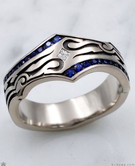 This phenomenal wedding band for men was inspired by tribal tattoo imagery. Over one quarter carat of blue sapphires is channel set in the ring, with a white princess cut diamond flush set diagonally in the center. The recesses are darkened. Truly a stand apart ring. To choose different colors for the accents in the channels, just select your choice of fancy diamonds or sapphires! Mens Sapphire Wedding Band, Non Traditional Wedding Ring, Jewelry Rings Unique, Blue Wedding Band, Wedding Band For Men, Mens Ring Designs, Sapphire Wedding Rings, Sapphire Wedding Band, White Princess