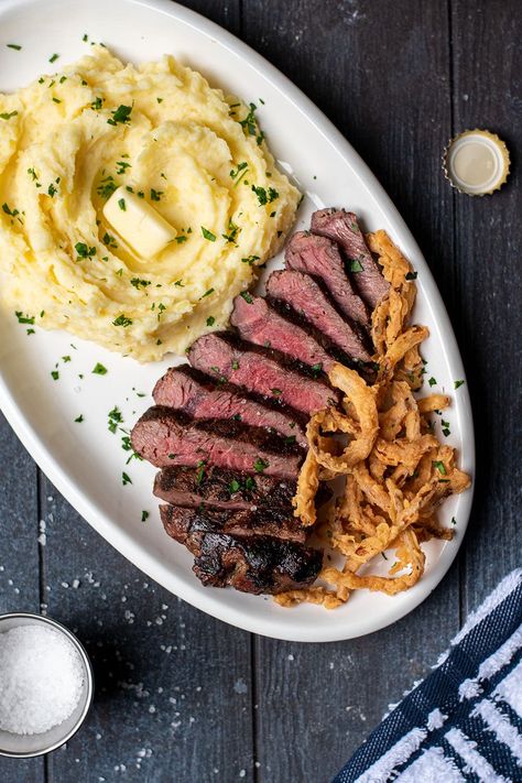 Garlic Butter Steak with Fried Onion Strings and Mashed Potatoes Recipe Steak And Mash Potatoes, Fried Onion Strings, Steak With Mashed Potatoes, Steak And Mashed Potatoes, Onion Strings, Strip Steak Recipe, Crispy Baked Potatoes, Steak And Potatoes, Fried Steak Recipes