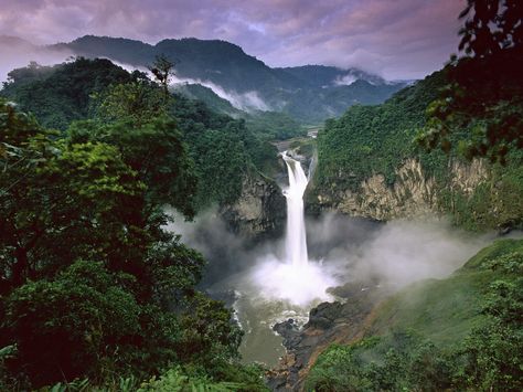 Spanning across Brazil, Peru, Colombia, Venezuela, Ecuador, Bolivia, Guyana, Suriname and French Guiana, the Amazon Rainforest has been named one of “New 7 Wonders of Nature.” This lush region has unparalleled biodiversity. In fact, one in ten known species in the world lives in the Amazon Rainforest. Large Waterfall, Amazon Forest, Amazon Rainforest, Holiday Destinations, Places Around The World, Most Beautiful Places, Natural Wonders, Honduras, Ecuador