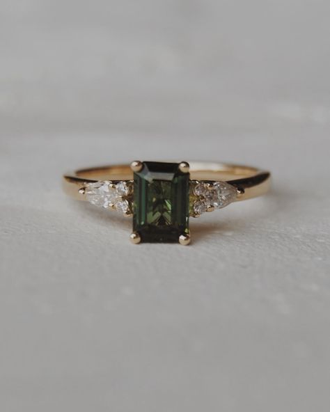 Congratulations Quin + Rae 🥹💍🍾 We customized our Elsie setting, switching out the centre stone for a stunning 6x4mm natural dark green tourmaline with pear and round accents. We wish you the best for your engagement season!! Engagement photos by the lovely: @jordanfayephotography Dark Diamond Ring, Green Topaz Ring, Gold Ring With Emerald Stone, Green Gold Engagement Ring, Natural Engagement Ring, Dark Green Sapphire Engagement Ring, Dark Emerald Engagement Ring, Dark Engagement Rings, Engagement Rings Green Stone