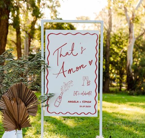 Unique Engagement Party Welcome Sign Hand written Hand-painted Pizza Rehearsal Dinner Welcome To our engagement Decor Couple Shower Pizza Theme Wedding DIY Bridal Shower Bachelorette Party Adult Birthday Welcome Board Hens Party Decoration -------------------- The listing is for Hand drawn That's Amore Engagement Party Wedding Welcome Sign Template. This design features my hand lettered "That's Amore" and trendy illustration style with champagne bottle, engagement ring and wavy border, a great w Laid Back Engagement Party, Thats Amore Sign, Italian Style Engagement Party, Backyard Fall Engagement Party, Italian Wedding Welcome Party, Italian Themed Engagement Party Ideas, Engagement Party That’s Amore, Perfect Pair Engagement Party, Bridal Shower Valentines