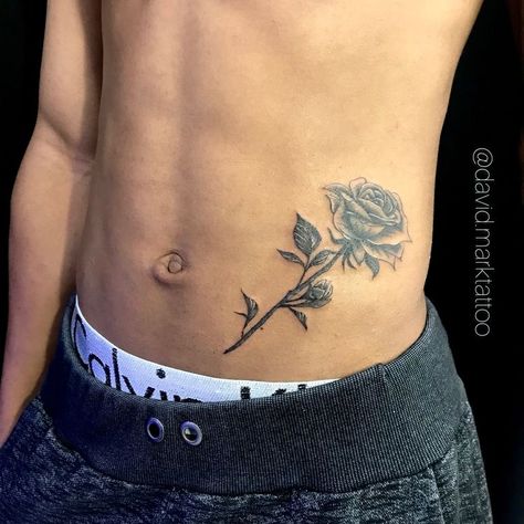 Waist Tattoos Men Lower, Stomach Rose Tattoo, Men’s Tattoos Stomach, Side Chest Tattoo Men, Simple Tattoos Men Chest, Side Torso Tattoo Men, Small Stomach Tattoos For Guys, Lower Abs Tattoo Men, Small Tattoo On Chest