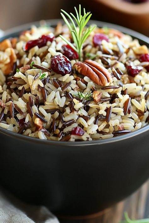 Cranberry Pecan Wild Rice Pilaf is a flavorful dish made with wild rice, cranberries, and pecans. Ideal for special occasions or as a healthy side, this colorful pilaf offers a perfect taste balance. Baked Wild Rice Recipes, Wild Rice With Cranberries, Wild Rice With Cranberries And Pecans, Slow Cooker Rice Pilaf, Wild And Brown Rice Recipes, Wild Rice Cranberry Pilaf, Wild Rice Pilaf Recipe Easy, Cranberry Rice Pilaf, Wild Rice Pilaf With Cranberries