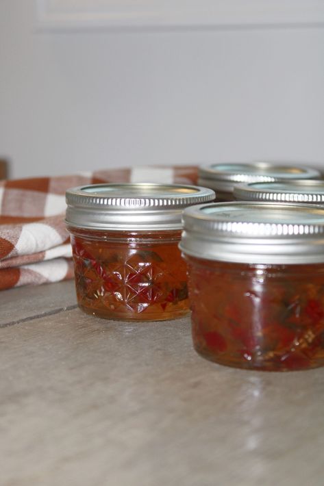 This simple pepper jelly is the perfect way to use up your summer pepper harvest.#canning #holidaygifts #sonyaburgess Strawberry Pepper Jelly, Banana Pepper Jelly, Canning Pepper Jelly, Cherry Bomb Pepper, Red Pepper Jelly Recipe, Canning Peppers, Pepper Jelly Recipes, Red Pepper Jelly, Jalapeno Jelly