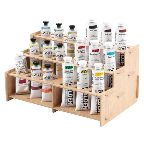 Mezzo Straight Rack 2, Artist Paint Rack - Upright, Easy to view, Paint and Brush Organizing System Upright, Easy to view, Paint and Brush Organizing System - Buy Direct & Save More! The Mezzo Paint Racks offer a simple solution for studio organization. The rack helps you to organize your paints while also making it easy to grab what you need while painting. The unique pairs of football-shaped holes and bottom slots allow you to display paint tubes upright in a variety of sizes. The Mezzo allows you to focus on the paints you are using by making them more visible. You could even use multiple sets to display and organize a larger collection of paints. The configuration possibilities are endless! Mezzo Straight Rack 2, Artist Paint Rack Key Features: Easy assembly Upright, easy to view, orga Artist Studio Storage, Brush And Paint, Artist Storage, Paint Tube, Studio Storage, Paint Rack, Professional Art Supplies, Paint Organization, Wooden Tool Boxes