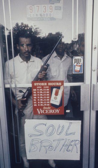 A store owner guards his property in Detroit during the 1967 riots, behind a sign he made that, he hoped, might help spare his shop from attack by roving mobs. Lee Balterman—Time & Life Pictures/Getty Images Detroit Ruins, Detroit Riots, Detroit History, Store Owner, Time Life, Civil Rights Movement, Motor City, Pure Michigan, Detroit Michigan