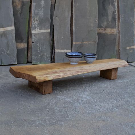 Bring warmth and character into your home with this beautiful low bench made from reclaimed oak. We celebrate the natural beauty of the wood by intentionally keeping its cracks, knots, and other charming imperfections intact, giving the bench a raw, authentic rustic look. Versatile and stylish, it can also serve as a narrow coffee table or console table, perfect for smaller spaces. The surface features visible milling marks, adding a handcrafted touch. The shape tapers gracefully, with one side narrower and the other wider, creating a unique, organic silhouette. Solid square legs with natural cracks further complement the rustic aesthetic. Dimensions: Length: 110 cm (43.3 inches) Width: 18 cm to 37 cm (7.1 to 14.6 inches) Height: 17 cm (6.7 inches) This timeless bench is not only a practic Wabi Sabi Bench, Narrow Coffee Table, Low Console, Low Bench, Reclaimed Wood Benches, Rustic Console, Rustic Bench, Entryway Mudroom, Rustic Aesthetic