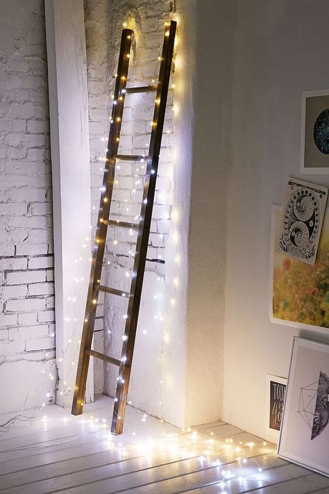 Make a decorative ladder Christmas-ready by encasing it in lights. Ladder Christmas Decor, Ladder With Lights, Rustic Ladder Decor, Wood Ladder Decor, Wooden Ladder Decor, Hanging Ladder, Ladder Ideas, Front Door Entry, Fairy Lights Decor