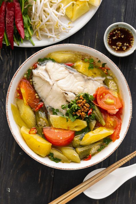 Canh Chua is an iconic Vietnamese Sour Soup, loved for its broth that's sweetened by pineapple and garnished with fresh herbs! #vietnamesesoursoup #vietnamesesoup #canhchua Vietnamese Sour Soup, Vietnamese Fish Soup, Canh Chua Recipe, Banh Canh Recipe, Catfish Soup, Sour Fish Soup, Sweet And Sour Fish, Canh Chua, Vietnamese Soup