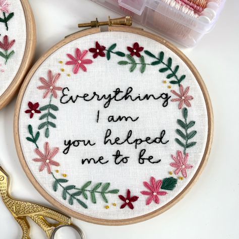 Embroidery hoop with white fabric and hand embroidered Mother’s Day quote in black thread saying Everything I am you helped me to be. Hand embroidery flowers around wording with green stitched leaves. Hand Embroidered Gifts, Everything I Am, Mum Gifts, Diy Embroidery Designs, Felt Gifts, Contemporary Embroidery, Embroidered Gifts, Hand Embroidery Projects, Embroidery Gifts