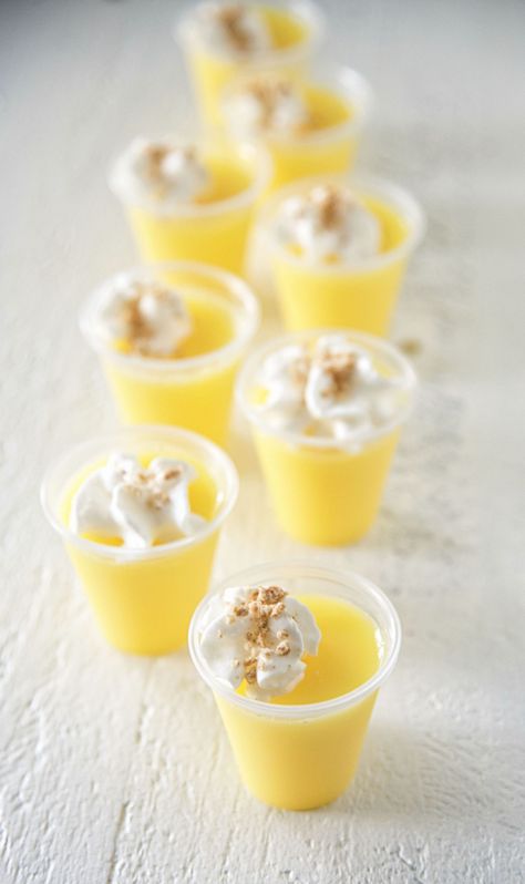 Lemon Cheesecake Jell-O Shots Lemon Themed Bridal Shower Desserts, Lemon Themed Desserts, Lemon Themed Food, Yellow Foods For Color Party, Fancy Jello Shots, Yellow Party Foods, Best Jello Shot Recipes, Lemon Jello Shots, Pudding Shot Recipes