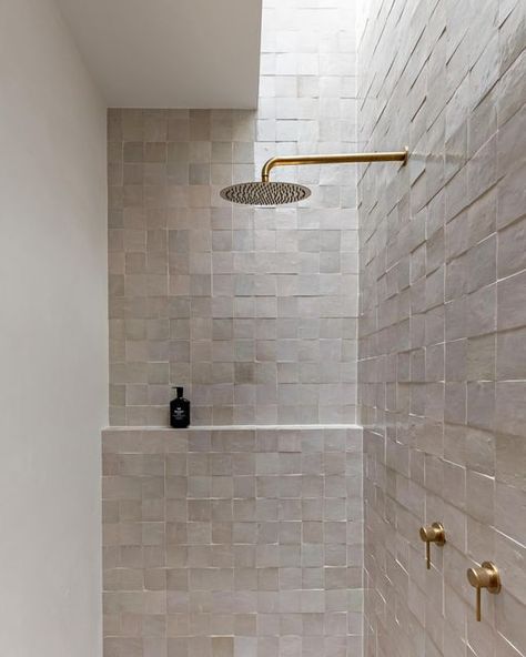 HAAUS.® on Instagram: "Our HAAUS.5 ensuite bathroom is definitely a space you walk into and instantly feel a sense of calm. Zellige tiles paired with brushed brass fixtures = simplicity and elegance in every detail. ✨   The addition of a skylight elevates the ambiance, casting a serene glow over the textures. Who wouldn’t want to shower in here! 😍  Create the Look ~ Wall Tiles: @ambertiles Zellige Ecru Terracotta Moroccan Square Gloss ~ Wall Tile Grout: @ardexaustralia FG8 #248 in Walnut from @ambertiles  ~ Shower Head: @adpaustralia Soul Rain Shower Rose Brushed Brass ~ Shower Arm: @adpaustralia Soul Shower Arm 450mm in Brushed Brass ~ Mixer: @adpaustralia Soul Grove Wall Mixer in Brushed Brass ~ Shampoo: @leifproducts Blue Cypress Shampoo ~ Floor Tiles: @ambertiles Cavestone Sahara 600 Square Tile Bathroom, Recycled Glass Tile, Zellige Tiles, Space Saving Bathroom, Shower Rose, Stone Bathroom, Stunning Bathrooms, Brass Shower, Zellige Tile