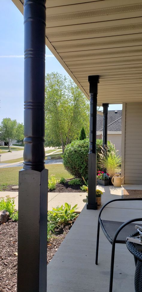 Black Porch Pillars, Black Porch Posts Columns, Black Stained Porch Columns, Black Pillars On Front Porch, Black Porch Posts, Black Front Porch Columns, Black Porch Columns, Dark Wood Porch Columns, Wood Wrapped Wrought Iron Porch Columns