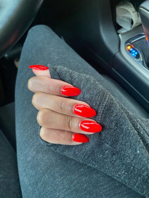 These are freshly manicured acrylic nails  with a short almond shape. The nail color polish is red on a medium brown skin tone. Short Red Almond Nails Designs, Fruit Punch Nails, Short Almond Red Nails Design, Fire Engine Red Nails, Ferrari Inspired Nails, Red Apple Nails, Dnd Ferrari Red, Red Ferrari Nails, Strawberry Red Nails