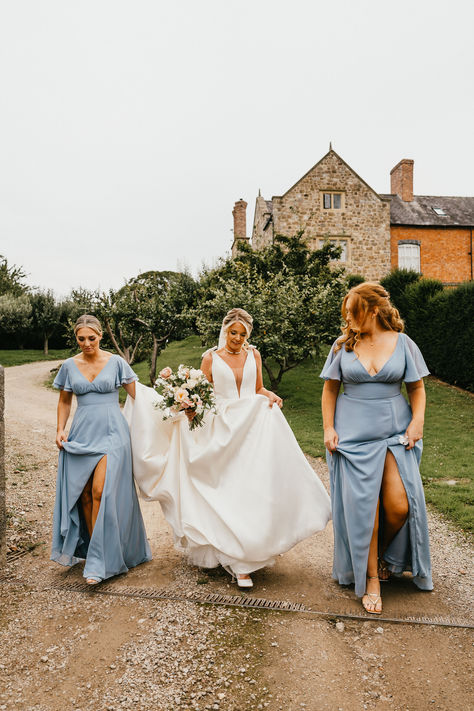 Bridesmaids in powder cornflower blue bridesmaid dress with butterfly sleeves and plunging neckline walking with bride in bow wedding dress with neutral wedding bouquet | bridal style | blue wedding theme | blue wedding fashion and outfits | Jessica Hopwood Photography Cornflower Bridesmaid Dresses, Cornflower Blue Bridesmaid Dress, Cornflower Blue Wedding Flowers, Blue Bridesmaid Dresses With Wildflowers, Cornflower Blue Wedding Palette, Corn Flower Blue Bridesmaid Dresses, Cornflower Dress, Cornflower Blue Bridesmaid Dresses, Cornflower Blue Dress