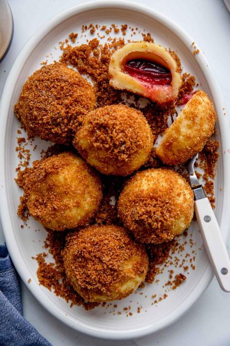 Plum Dumplings with Ricotta is a delicious dessert. You can use your favorite fruits in this simple family favorite recipe. They are well known in Austria, Poland, and over here in Slovenia. Kids and adults love them and you can easily make them up to three months ahead. #jernejkitchen #plumdumplings #plumrecipes #autumnrecipes #ricotta #slovenianrecipes #dessert Healthy Plum Dessert, Easy Cultural Recipes, Baking With Fruit, Plum Recipes Dessert, What To Do With Plums, Recipes With Plums, Slovenia Recipes, Plum Dessert Recipes, Breakfast Dumplings