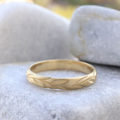 "Celebrate your love with our Leaf Engraved Wedding Band. This nature-inspired gold ring features delicate leaf engravings, making it a beautiful choice for wedding rings. The textured gold adds a touch of elegance, creating a unique and meaningful piece. Whether as a wedding band or a symbolic accessory, this engraved ring captures the essence of nature and enduring love. Measurements: * Material: High Quality Solid Gold 14k or 18k * Ring Width: 3.00 m\"m * Ring Height (Thickness): 1.20 m\"m ------CUSTOMIZATION------ ♥ Feel free to contact me for any other customization to your preferences. How to order: * Ordering is easy! Just use the Menu Bar to pick the size and gold material you want for the ring, and then place your order. We'll make the wedding band just for you, and it will be rea Nature Wedding Band, Engraved Wedding Band, Textured Wedding Band, Wedding Band Gold, Leaf Wedding Band, Wedding Band Engraving, Nature Inspired Rings, Engraved Ring, Engraved Wedding