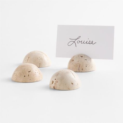 Hemispheres of pure travertine serve as chic holders for personalized place cards. Slotted to hold a card indicating seating or identifying a dish on a buffet table or cheese spread, each holder in the set exhibits the natural earth tones and unique markings of travertine.   • Travertine  • Slotted to hold place cards  • Due to the characteristics of natural stone, markings and coloration will vary  • Wipe clean with damp cloth  • Made in India Travertine Round Placecard Holders, Set of 4 Wedding Table Setting With Name Card, Wedding Thrift, Place Holders Wedding, Wedding Seating Chart Display, Wedding Table Display, Minimalist Stationery, Personalized Place Cards, Place Card Table Wedding, Colorful Wedding Invitations