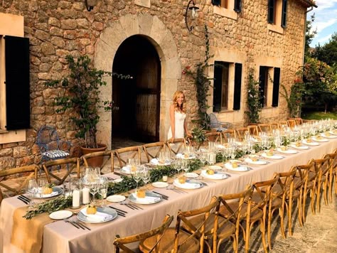 Rustic wedding table decor with olive leaf garland runner, candles lanterns and lemon place cards. Alfresco candlelight dinner table in Mallorca. Centerpiece and decorations. Mallorca Wedding Table, Olive Leaf Wedding Decor, Olive Leaf Centerpiece, Candlelight Dinner Table, Cream Wedding Theme, Leaf Table Decor, Wedding Reception Candles, Garland Table Runner, Tuscan Table