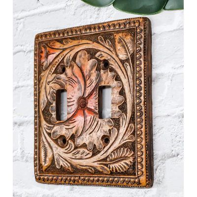 This Western Faux Wooden Tooled Floral Blossoms Wall Electrical Cover Plates each measures 5.25" High, 4.75" Wide and 0.25" thick approximately. They fit standard wall receptacles. Each plate weighs about 5 ounces. | Bungalow Rose Ramonita 2-Gang Duplex Outlet Wall Plate in Brown / Orange | 6 H x 5 W x 1 D in | Wayfair Faux Wood Wall, Pine Tree Silhouette, Custom Leather Work, Gift Catalog, Horse Wall, Toggle Switch, Wooden Background, Western Decor, Wall Plate