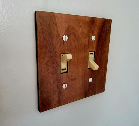 Up your light switch game! These fit standard toggle switch plates. Available in Walnut (shown), Cherry, and Maple. Specify 1, 2, 3, or 4 switches! Looking for large toggle switch style covers? Let me know, and I can also create those. These can also be made as custom orders with custom laser etching - light names, images, etc. Please contact me for more information for a custom order. Please reach out with any questions or issues!   These items are mostly made to order, and may take a couple of Wood Outlet Covers, Light Names, Vintage Eclectic Home, Light Switches And Sockets, Switch Socket, Surf House, Toggle Light Switch, Light Switches, Toggle Switch