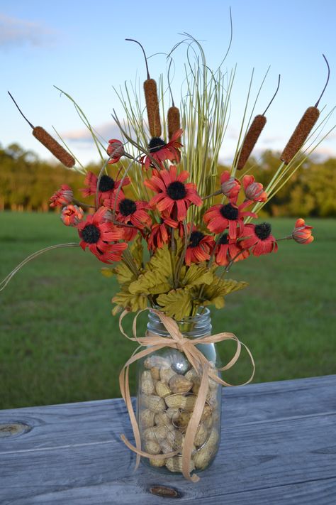 Fall floral arrangement using mason jar, fall flowers, cat tails, and fresh peanuts. Cattail Centerpieces, Bull Rushes, Mason Jar Planter, Fall Floral Arrangement, Childrens Party Decorations, Cat Tails, Trumpeter Swan, Jar Centerpieces, Fall Flower Arrangements