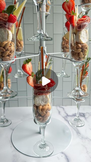 The Board Loon | Kelsey Bassett on Instagram: "Champagne Charcuterie Tower 🥂🧀
Found this champagne tower on Amazon and just knew I had to Charcuterize it. Charcuterize? I think I am making that a thing 😂 Anyway, turn heads at your next event by displaying your charcuterie this way. Buy two and have one for actual champagne too 😁 Comment the word Cheers and I’ll send the link to the tower! 

✨Follow along for more Charcuterie Boards, Midwest Accents, Tutorials, Recipes & more!
.
📬 : TheBoardLoon@gmail.com 
.
💻 : Www.TheBoardLoon.com
.
. @TheBoardLoon also on TikTok & Facebook
.
 #charcuterie #recipe #tutorial #theboardloon #cheeseboard #tutorial  #cheese #charcuterieboard  #appetizers #board" Champagne Charcuterie Cups, Food In Champagne Glasses Party Ideas, How To Do A Champagne Tower, Charcuterie Tower, Champagne Tower Bridal Party, Charcuterie In Champagne Coupe, Charcuterie In A Champagne Flute, Champagne Tower Plastic Cups, Appetizers Board