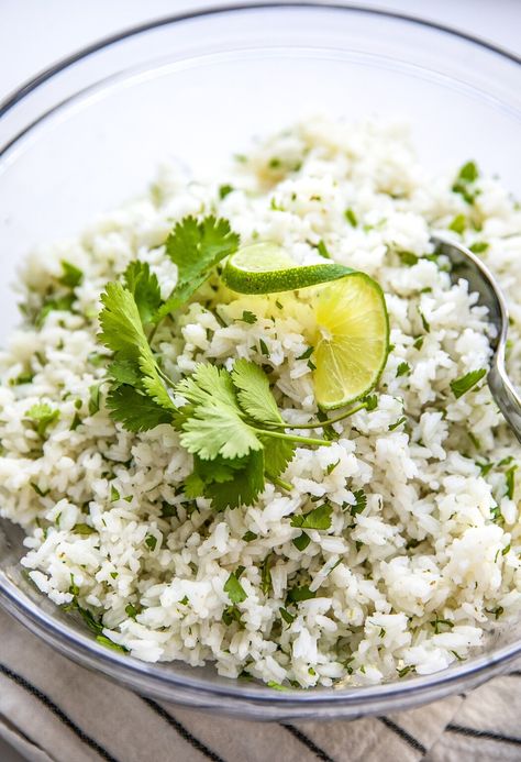 Bright and zesty, this easy cilantro lime rice is a fluffy rice side with an unexpected burst of flavor. Topped with extra cilantro for a pop of color, it's a simple 30-minute recipe that'll add extra personality to your meals. Easy Cilantro Lime Rice, Cilantro Rice Recipe, Cilantro Lime Rice Recipe, Lime Rice Recipes, Cilantro Rice, Chicken Tacos Crockpot, Fluffy Rice, Rice Side, Rice Side Dishes