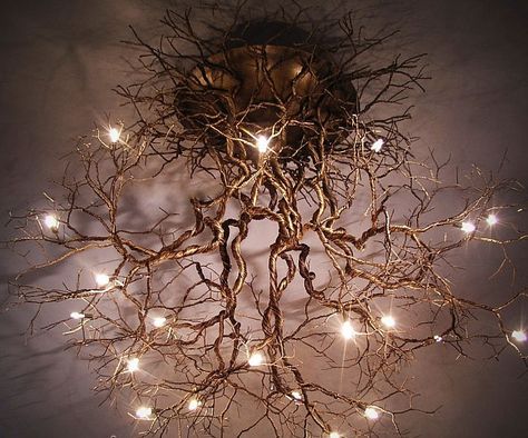 Take an interior decorating cue from Mother Nature herself by illuminating your home with this tree roots ceiling lamp. This work of art features a pewter wire design resembling an interconnected web of roots with light bulbs scattered all throughout the structure. Ceiling Fairy Forest Lights, Tree Chandelier Modern, Tree Branch Chandelier Living Room, Driftwood With Fairy Lights, Driftwood Log With Lights, Luminaire Original, Deco Luminaire, Tree Roots, Natural Home Decor