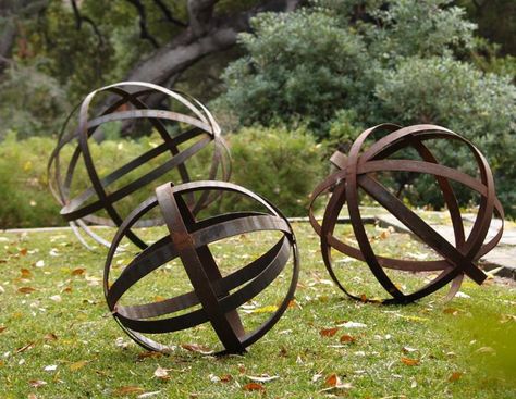 Rusted Iron Spheres  The Rusted Iron Spheres are available in three sizes: 18, 24, and 36-inches in diameter, starting at $145 at Potted. Corten Steel Garden, How To Make Iron, Garden Spheres, Unique Garden Art, Barrel Rings, Decorative Spheres, Metal Garden Art, Unique Gardens, Diy Metal