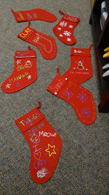 We felt inspired by the holidays and took some time to decorate stockings at the Fargo RealTruck office. Here are a few of the festive creations. Thanks to felt stocking and puffy paint, these turned out great! Stocking Decorating Ideas For Kids, Puffy Paint Stocking Ideas, Stocking Decorating Ideas Diy Glitter, Painting Stocking Ideas, Decorate Stockings Christmas, Decorate Stockings, December Decor, Stocking Decorations, Afterschool Program