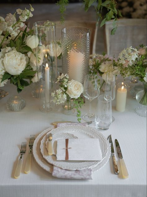 A stunning wedding tablescape adorned with delicate white florals, lace-edged plates, and soft candlelight. Thoughtful touches, like hand-tied menu cards and textured glass candle holders, create a timeless and intimate ambiance. The perfect inspiration for an effortlessly elegant wedding reception.

Photographer: Anya Kernes Romantic Candlelit Wedding, Ethereal Garden, Candlelit Wedding, Elegant Wedding Reception, Wedding Tablescape, Event Floral Design, White Florals, Luxury Event, Event Services