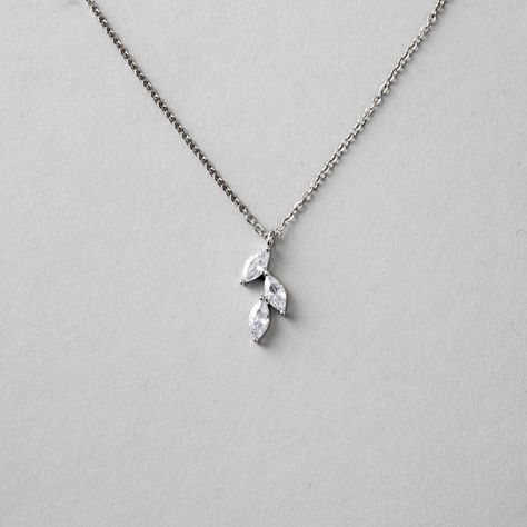 This minimalist style is created with three marquise leaf CZ stones and set in rhodium silver or gold plate. A tiny bright necklace for the bride or bridesmaids. The pendant is 5/8 of an inch long and the necklace is 16.5 inches with a two inch extender. #bridetobe24 #wesaidyes #weddingjewelryforsale #bridesmaidgifts #bridalaccessories #isaidyes #weddingaccessories Bright Necklace, Bridemaids Gifts, Leaf Necklace, Leaf Pendant, Simple Necklace, Bridesmaid Jewelry, Cz Stone, Silver Leaf, Minimalist Style