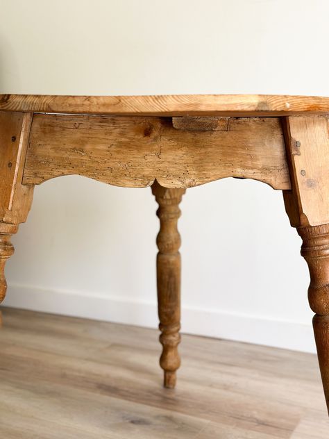 This stunning table boasts the perfect patina and wood tone. The elegant turned legs and feet set this piece apart from traditional cricket tables with these extra design notes. Please note that the top is not a perfect. The compact size of this table make it perfect for small spaces. Dimensions: 35" wide x 29" tall x 35" deep **Due to the unique antique and vintage nature of our pieces, all sales are final and sold as is. Our items are one-of-a-kind and can have wear consistent with age, including nicks, cracks, and patina which only adds to the character. Please be sure to ask any questions related to condition prior to purchase.** Antique Tables, Primitive Tables, Vintage Tea Cart, Antique End Tables, Puzzle Table, Antique Side Table, Antique Dining Tables, Pine Furniture, Cottage Interior