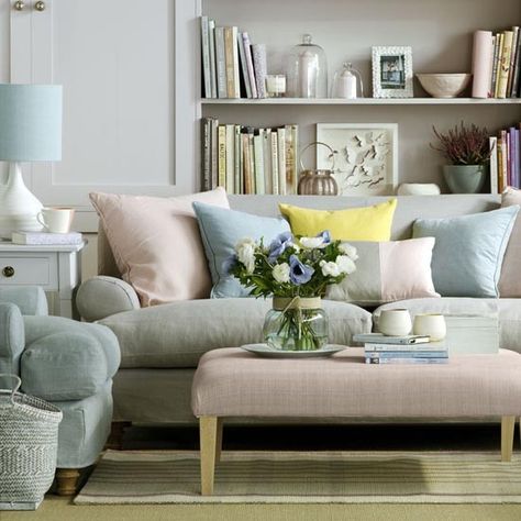 Create a calming, restful scheme with a palette of soft pastels. Co-ordinate your upholstery in tonal pastel shades; try a sofa, chair and footstool in a mix of grey, pale blue and shell pink, then add cushions and throws in matching shades. Line shelves with pretty pastel accessories, as rows of books in sugary tones will complement the scheme. Pastel Living Room, Deco Pastel, Spring Living Room, Spring Interiors, Green Couch, Yellow Living Room, Home Trends, Small Living Room, Decor Rustic