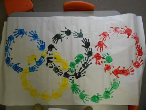 Olympic Rings done with the Preschool Children's Hand prints ... Diy Olympic Torch, Torch Craft, Olympic Torch Craft, Summer Olympics Crafts, Vbs Olympics, Preschool Olympics, Olympics Decorations, Olympic Theme Party, Olympic Games For Kids