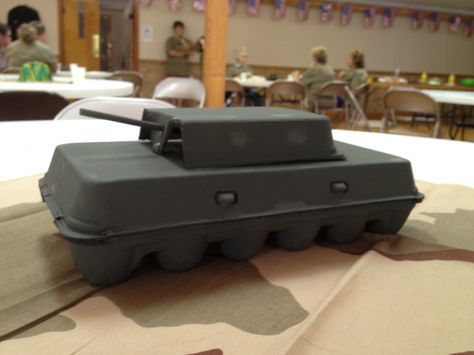 Army Tank made from an egg carton.  Teressa Janning made these for their VBS Boot Camp.  So creative! Army Tank Birthday Party Ideas, Army Theme Decorations, Army Vbs Decorations, Bible Boot Camp Vbs, Gods Army Vbs, Military Birthday Party Ideas Boys, Lords Army Vbs, Army Centerpieces, Tank Birthday Party