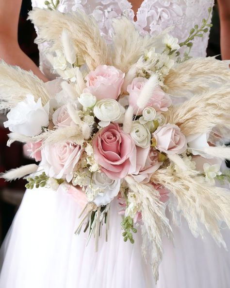 Delicate and dreamy. A stunning collection of fluffy ivory pampas punctuated with the most delicate shades of pink and white faux blooms and fluffy bunny tail stems. Bound with ivory satin ribbon. Pink And Pampas Wedding, Pink Boho Centerpieces, Peonies And Pampas Bouquet, Pink Pampas Wedding Decor, Pink Boho Bridal Bouquet, Pink And Pampas Bouquet, Pampas And Pink Flowers, Peach And Pink Wedding, Bridal Bouquet Pampas