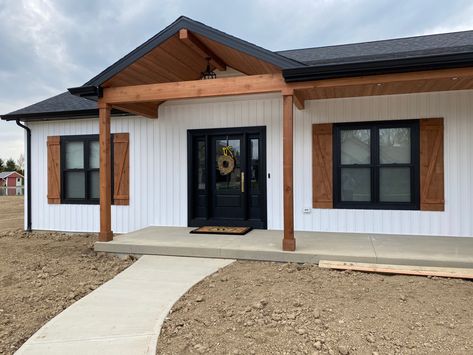 Cedar accents for the front. Cedar Ranch House Exterior, Black And White House With Cedar Accents, Front Deck Ranch House, Basic Home Exterior, Double Wide Paint Exterior, White House Black Trim Cedar Shutters, Single Wide Paint Exterior, White Manufactured Home Exterior, Modular Home Siding Ideas