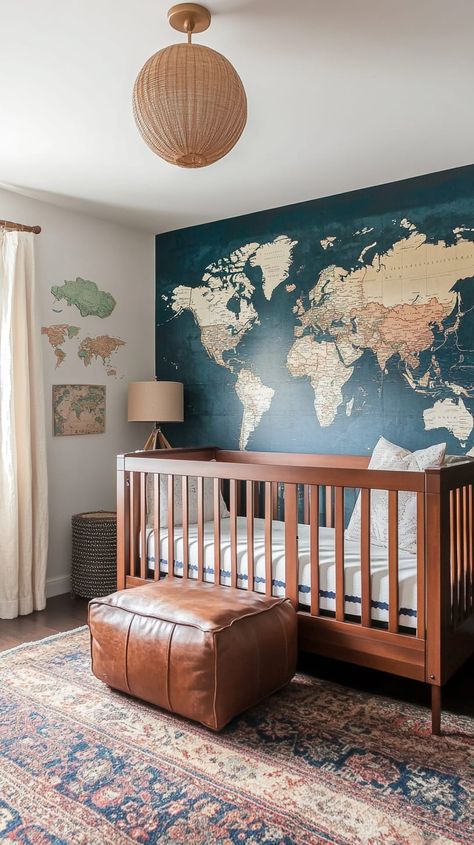 Cozy gender-neutral nursery featuring a world map accent wall, mid-century furniture, vintage maps, and a wooden crib. Travel Theme Nursery Boy, Travel Themed Nursery Neutral, Travel Inspired Nursery, World Nursery Theme, Baby Gender Neutral Nursery, Outdoor Themed Nursery, World Traveler Nursery, Adventure Themed Nursery, National Park Nursery