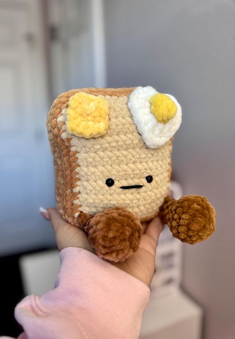 🤍Breakfast has never been this cute! 🥪 This Handmade Crochet Toast Plush is a chubby bundle of joy, featuring tiny feet, a playful expression, and adorable toppings--a sunny-side-up egg and a pat of butter. Perfect as a unique gift, quirky home decor, or a cheerful addition to your plush collection. Features: *🧶 Handcrafted with Love: Made from 100% polyester yarn, stuffed with soft fiberfill, and completed with safety eyes. as it is charming. *🍳 Tasty Toppings: Detailed with a fried egg and Crochet Cheese, Crochet Toast, Crochet Bread, Crochet Things To Make, Crochet Egg, Chunky Yarn Crochet, Kawaii Decor, Easy Beginner Crochet Patterns, Playful Expression