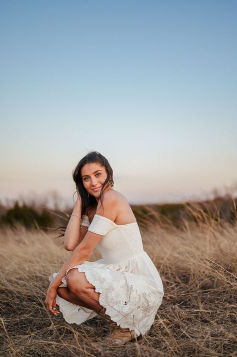 Beautiful brunette high school senior squats in white dress and cowboy boots in open field of tall grass in sunset with blue sky Senior Pictures Summer, Blue Hour, Senior Photo, Senior Portrait, Picture Collection, Senior Photographers, High School Seniors, Senior Photos, Photo Session