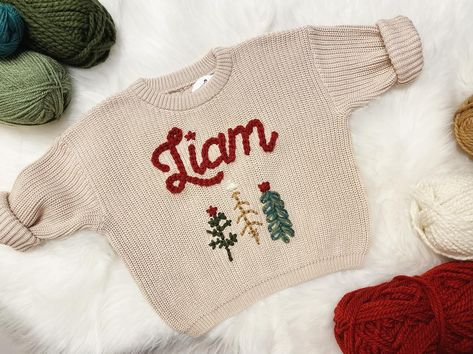 Our #1 Seller of all will remain on sale throughout the month of July, along with all Christmas designs. Snag yours at a discount while you can. These will not be marked down after this month☺️🌲❤️ #themodmango #themodmangobabyco #babychristmassweater #babysfirstchristmas #babysweater #babysweaters #christmasinjuly #custombabysweater #babyboutique #personalizedbabygift Chunky Yarn Sweater, Holiday Party Pictures, Name Sweater, Knit Baby Sweaters, Toddler Sweater, Embroidery Sweater, Baby Co, Toddler Christmas, Tree Pattern