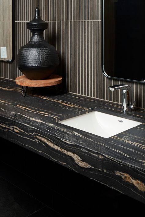 Add some drama to your master bath with natural stone! Click here to learn more: https://ecs.page.link/AwYug Featured Products: Belvedere Satin Granite (vanity) & Shibusa Wenge Stack (backsplash) #ArizonaTile #stonevanity #granitevanity Black Granite Bathroom Countertops, Black Granite Bathroom, Granite Bathroom Vanity, Cabana House, Titanium Granite, Backsplash Inspiration, Moody Bathroom, Living Room Lighting Design, Main Bathroom Ideas